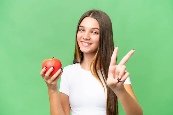 Teenager Kaukasischen Mädchen Hält Einen Apfel Über Isolierten Hintergrund Lächelnd — Stockfoto
