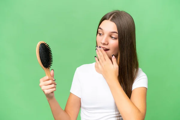 Teenager caucasian girl with hair comb over isolated background with surprise and shocked facial expression