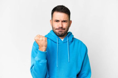 Young handsome caucasian man over isolated white background with unhappy expression