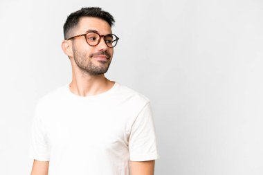 Young handsome caucasian man over isolated white background . Portrait