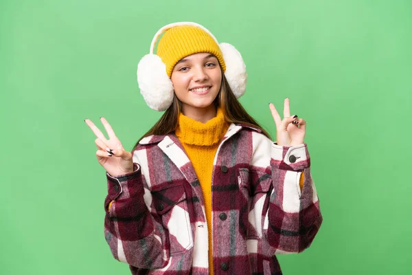 Teenager Caucasian Girl Wearing Winter Muffs Isolated Background Showing Victory — Stock Photo, Image