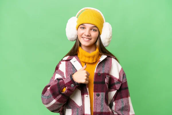 Teenager Caucasian Girl Wearing Winter Muffs Isolated Background Giving Thumbs — Stock Photo, Image
