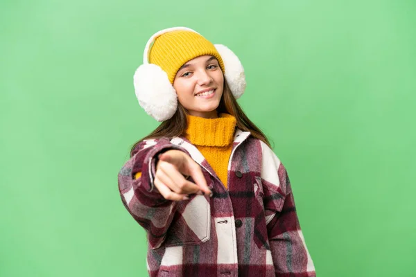 Teenager Caucasian Girl Wearing Winter Muffs Isolated Background Points Finger — Stock Photo, Image