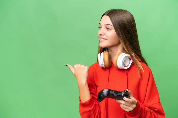 Teenager Caucasian Girl Playing Video Game Controller Isolated Background Pointing —  Fotos de Stock