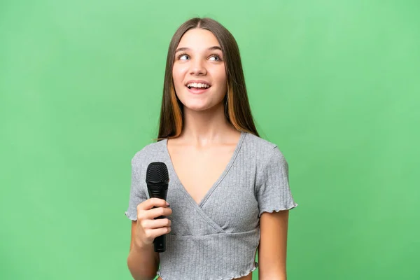 Teenager Singer Girl Picking Microphone Isolated Background Laughing — Foto de Stock
