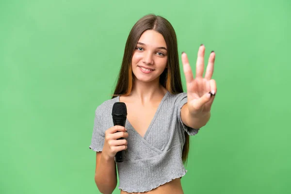 Genç Şarkıcı Kız Izole Edilmiş Bir Arka Planda Mikrofon Tutuyor — Stok fotoğraf