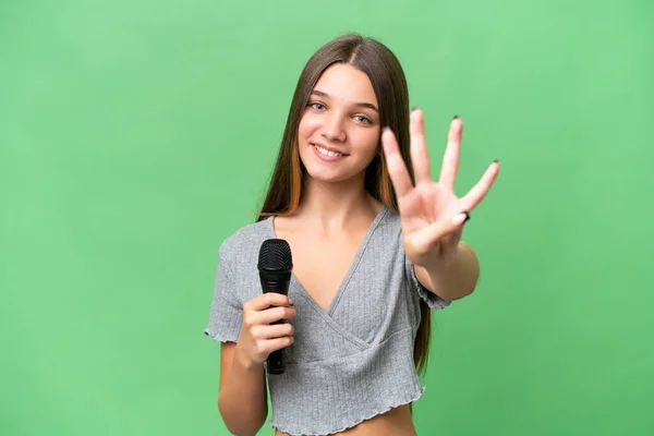 Genç Şarkıcı Kız Izole Edilmiş Bir Arka Planda Mikrofon Tutuyor — Stok fotoğraf
