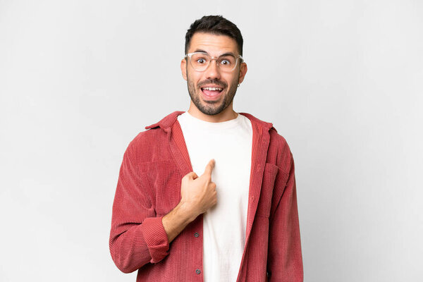 Young handsome caucasian man over isolated white background with surprise facial expression