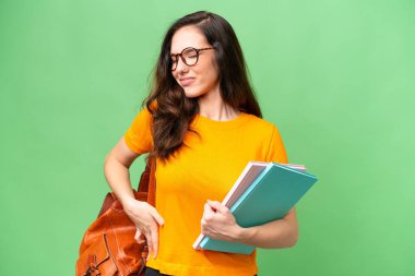 Young student caucasian woman over isolated background suffering from backache for having made an effort