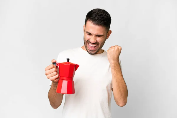 Young Caucasian Man Holding Coffee Pot Isolated White Background Celebrating — Stock fotografie