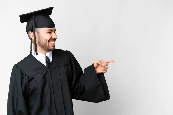 Young University Graduate Man Isolated White Background Pointing Finger Side — Photo
