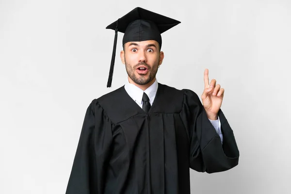 Joven Graduado Universitario Sobre Fondo Blanco Aislado Señalando Con Dedo — Foto de Stock