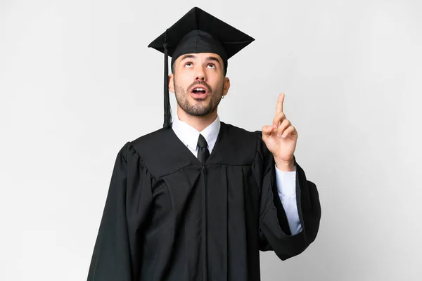 Mladá Univerzita Absolvent Muž Přes Izolované Bílé Pozadí Ukazuje Nahoru — Stock fotografie