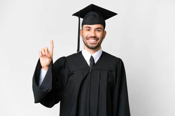 Молодий Випускник Університету Над Ізольованим Білим Тлом Показує Піднімає Палець — стокове фото