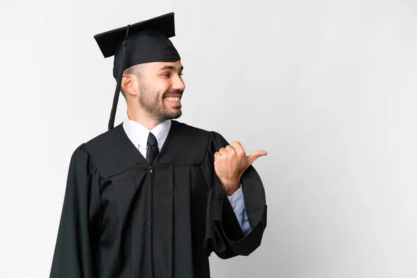 Young University Graduate Man Isolated White Background Pointing Side Present — Stock Fotó