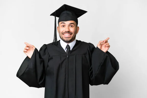 Νεαρός Απόφοιτος Πανεπιστημίου Πάνω Από Απομονωμένο Λευκό Φόντο Δείχνοντας Δάχτυλο — Φωτογραφία Αρχείου