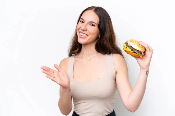 Young Caucasian Woman Holding Burger Isolated White Background Saluting Hand — Foto de Stock