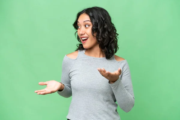 stock image Young Argentinian woman over isolated background with surprise expression while looking side