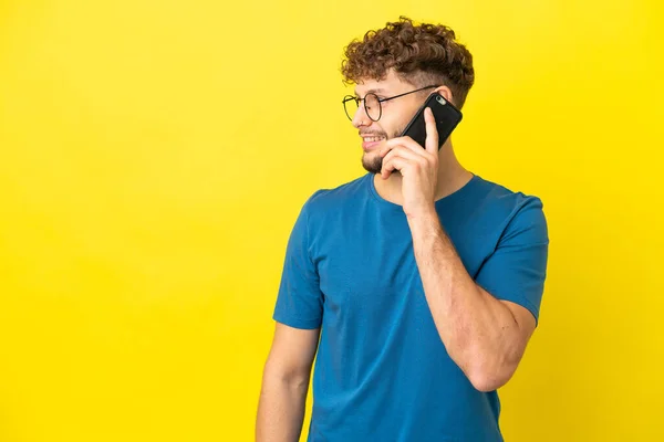 Young Handsome Caucasian Man Isolated Yellow Background Keeping Conversation Mobile — Fotografia de Stock