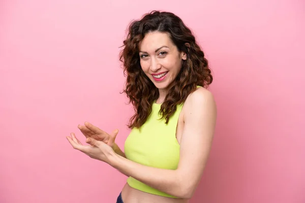 stock image Young caucasian woman isolated on pink background applauding