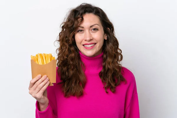 Young Caucasian Woman Catching French Fries Isolated White Background Smiling — Stock Fotó