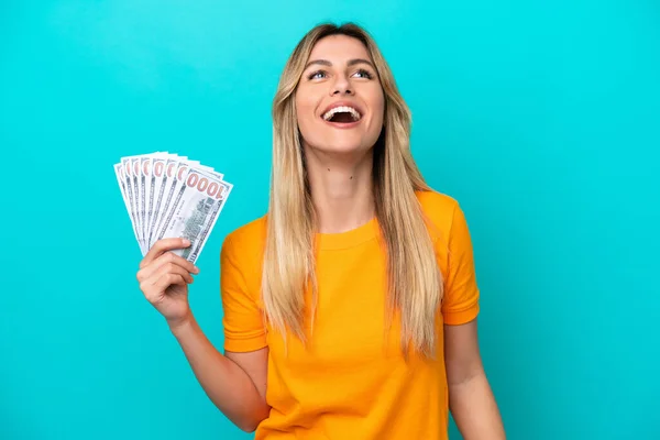 Young Uruguayan Woman Taking Lot Money Isolated Blue Background Laughing — 图库照片