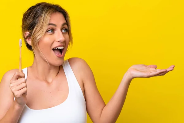 Young Uruguayan Woman Brushing Teeth Isolated Yellow Background Surprise Facial — Φωτογραφία Αρχείου