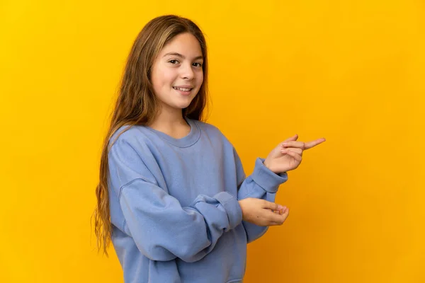 Child Isolated Yellow Background Pointing Finger Side — Stock fotografie
