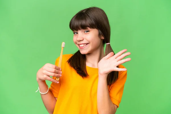 Little Caucasian Girl Brushing Teeth Isolated Background Saluting Hand Happy — Stock Photo, Image