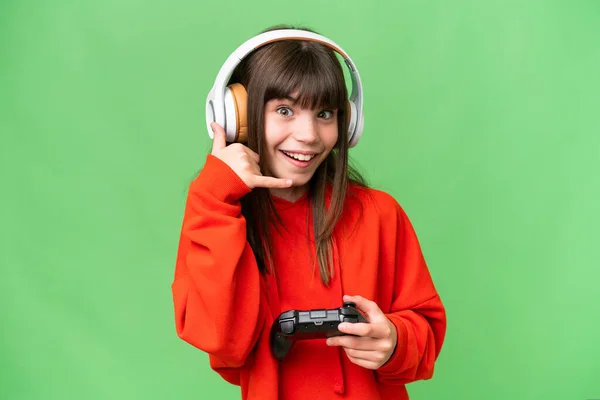 stock image Little caucasian girl playing with a video game controller over isolated background making phone gesture. Call me back sign