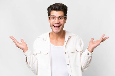 Young handsome caucasian man over isolated white background with shocked facial expression