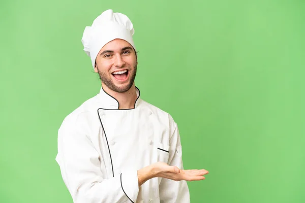 Jonge Knappe Chef Kok Man Geïsoleerde Achtergrond Presenteren Van Een — Stockfoto