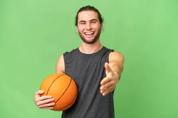 stock image Young basketball player man over isolated background shaking hands for closing a good deal