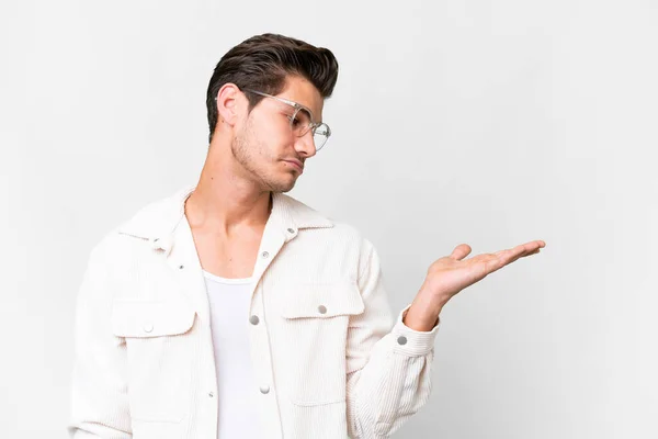 Young Handsome Caucasian Man Isolated White Background Holding Copyspace Doubts — ストック写真