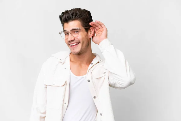 stock image Young handsome caucasian man over isolated white background listening to something by putting hand on the ear