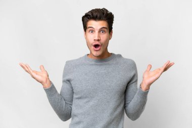Young handsome caucasian man over isolated white background with shocked facial expression