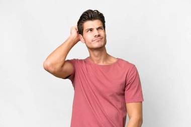 Young handsome caucasian man over isolated white background having doubts and with confuse face expression