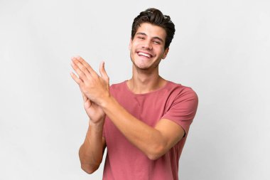 Young handsome caucasian man over isolated white background applauding after presentation in a conference