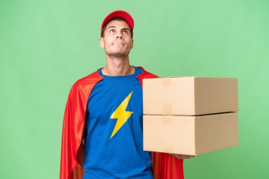 Super Hero delivery man over isolated background and looking up