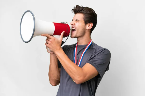 Young Caucasian Man Medals Isolated White Background Shouting Megaphone — Stockfoto