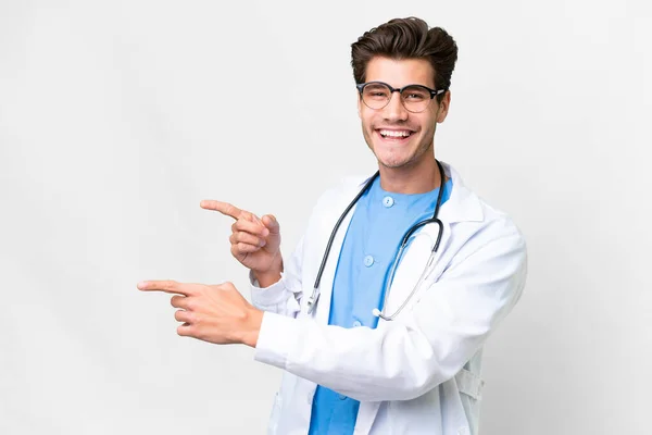 Junger Arzt Vor Isoliertem Weißen Hintergrund Zeigt Mit Dem Finger — Stockfoto