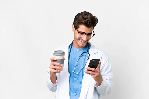 Young Doctor Man Isolated White Background Holding Coffee Take Away —  Fotos de Stock