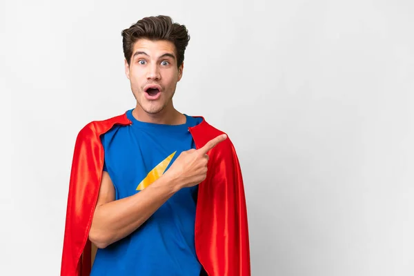 Super Hero Caucasian Man Isolated White Background Surprised Pointing Side — Zdjęcie stockowe