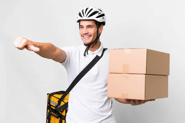 Delivery man wearing a helmet bike over isolated white background giving a thumbs up gesture