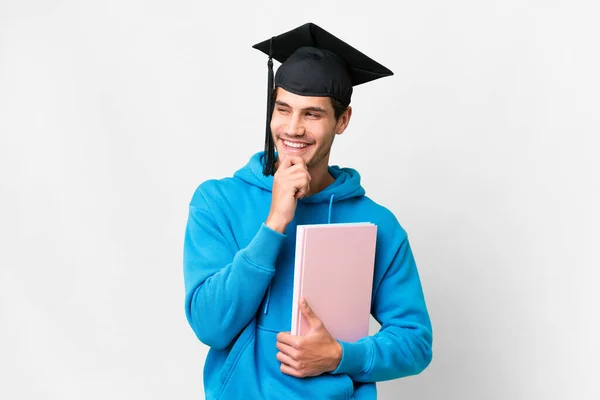 Young University Graduate Man Isolated White Background Looking Side Smiling — Stok fotoğraf