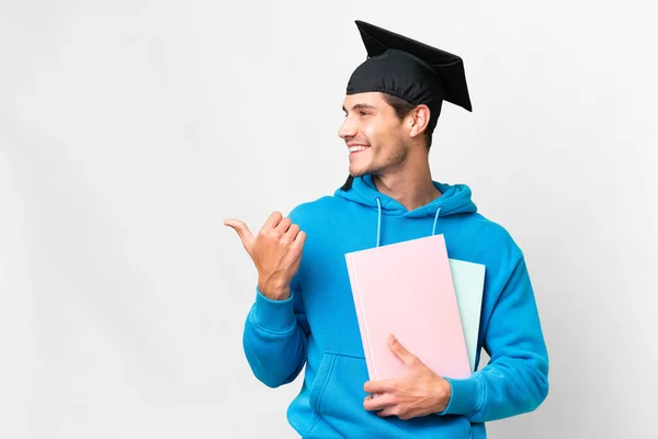 Young University Graduate Man Isolated White Background Pointing Side Present — Foto Stock