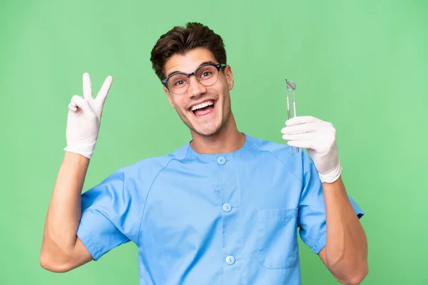 Jovem Dentista Homem Segurando Ferramentas Sobre Fundo Isolado Sorrindo Mostrando — Fotografia de Stock