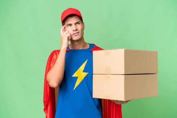Super Hero Delivery Man Isolated Background Having Doubts Thinking — Zdjęcie stockowe