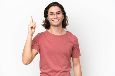 Beyaz arka planda izole edilmiş genç yakışıklı adam harika bir fikre işaret ediyor.