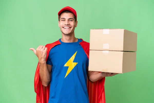 Super Hero Delivery Man Isolated Background Pointing Side Present Product — Stock Photo, Image